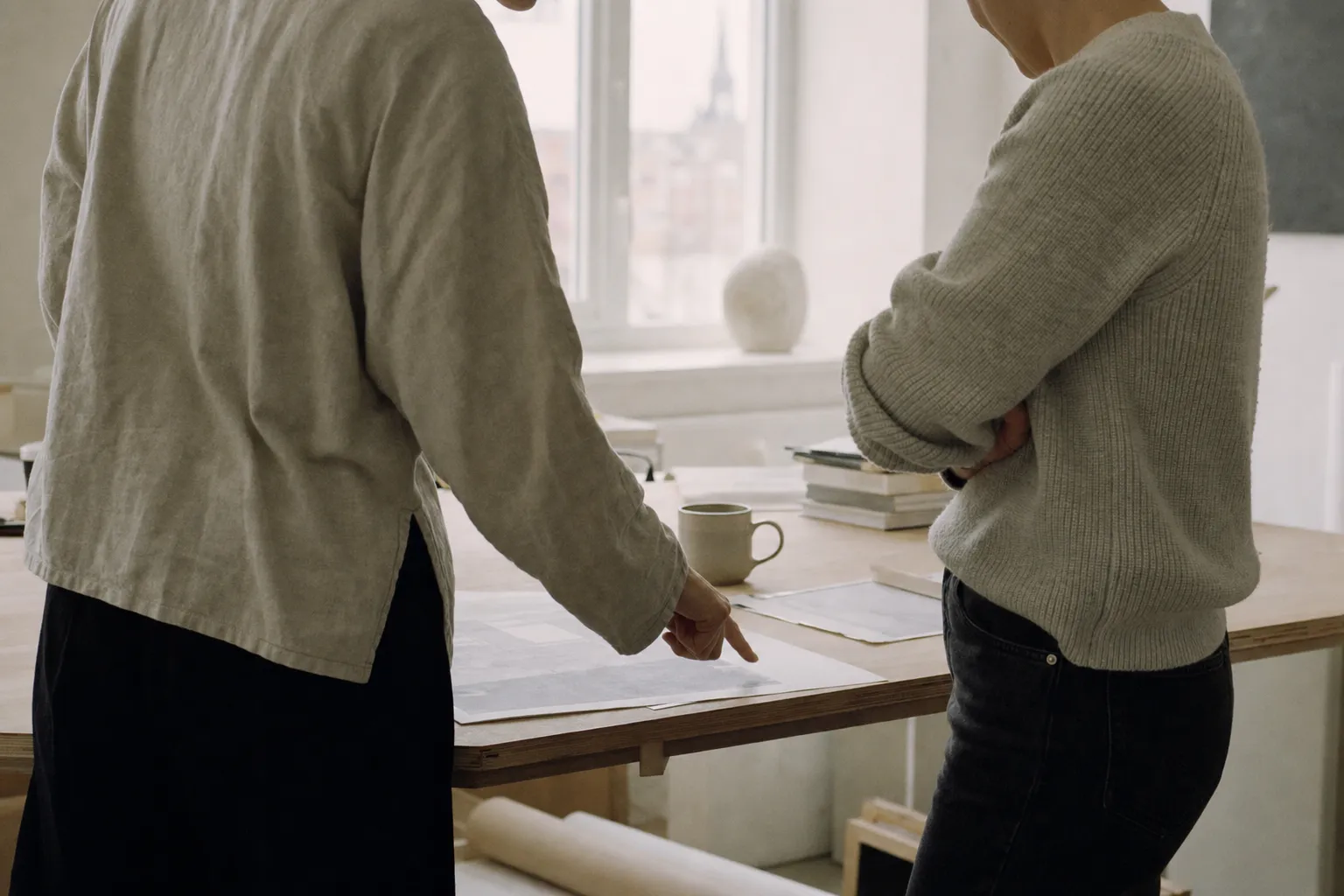Two colleagues reviewing a printed document together at a desk